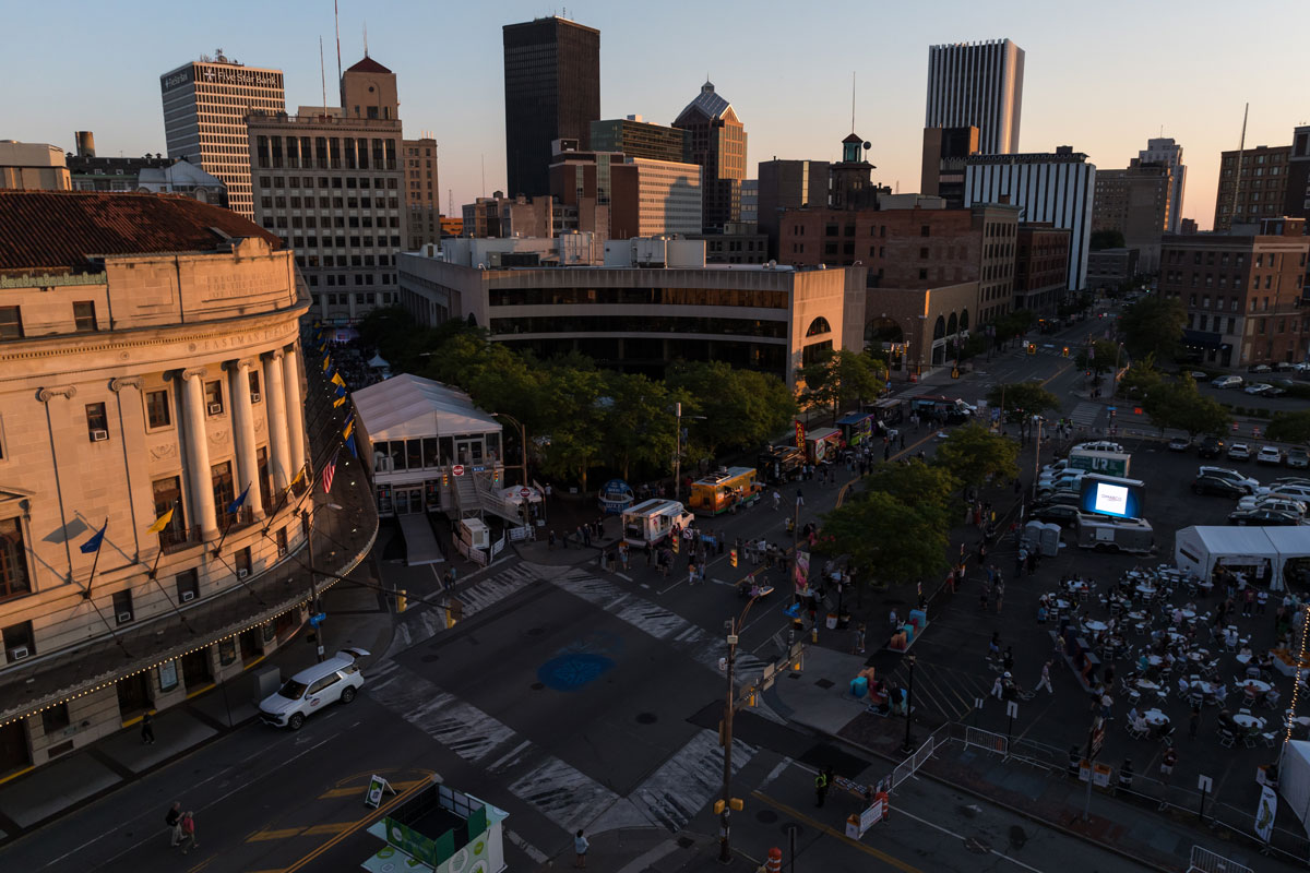 A large building stands prominently in the background during the University of Rochester Jazz Fest event.