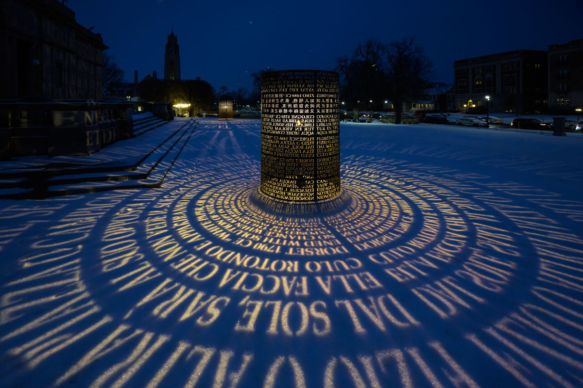 A large illuminated sculpture stands majestically in the snow at the University of Rochester Memorial Art Gallery.